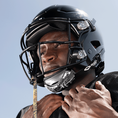 Football Athlete Wearing Showtime Chrome Silver Football Chinstrap with Football Tether Attached to Helmet