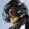 Football Athlete Wearing Showtime Chrome Gold Football Chinstrap with Football Tether Attached to Helmet